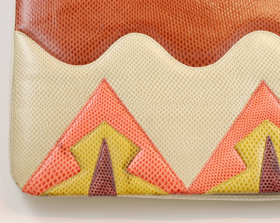 Geometric karung clutch/optional shoulder bag in tan and shades of brown, orange and mustard yellow by Judith Leiber from the 1980's.<br />
<br />
There is a detachable strap that measures 39