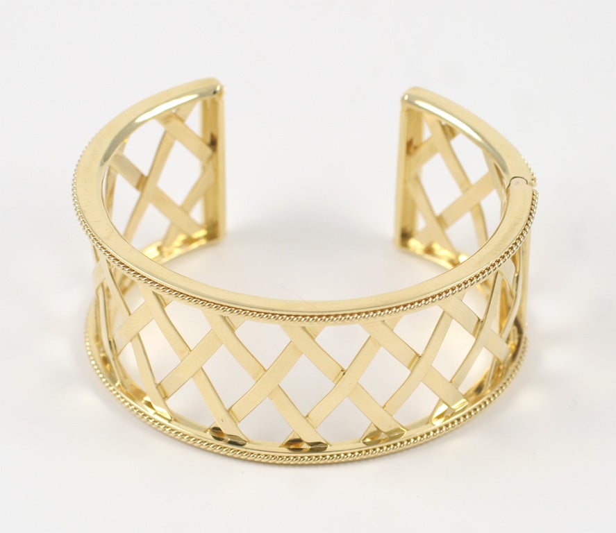 Elegant 18kt Yellow Gold Lattice band cuff with twisted rope edge Finished with a hinged opening.  A style statement!

The Cuff can be made to fit any wrist size.

The Cuff can also be made in 18kt White Gold or 18kt Rose Gold.