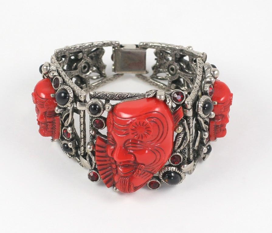 Intricately embellished bracelet with three red synthetic faces, black cabochons, and red rhinestones.  7  1/4