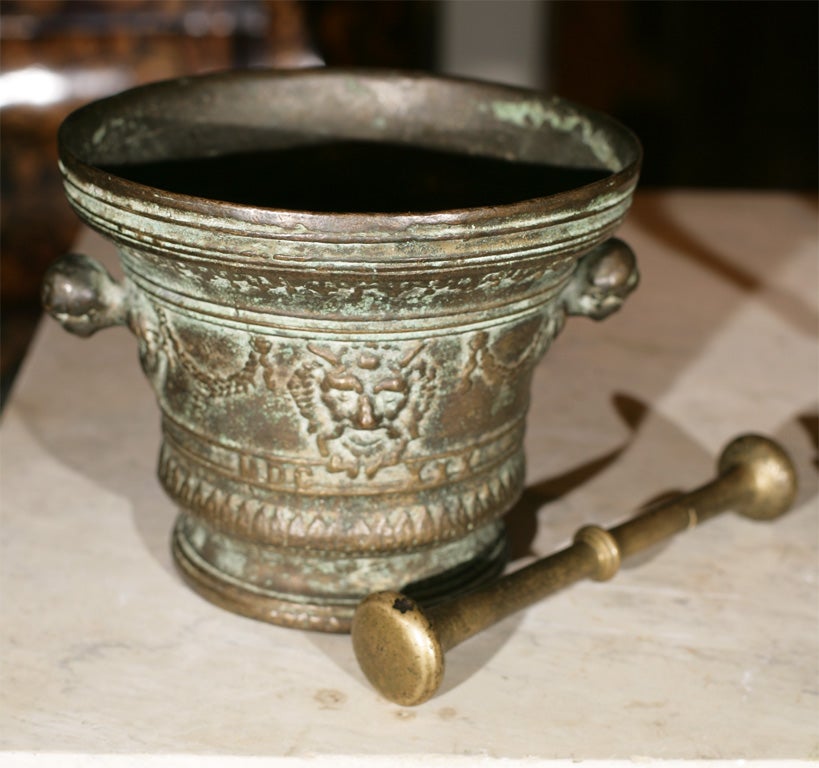 A  BRONZE MORTAR  AND PESTLE WITH MASKS ,HEAD HANDLES AND GARLANDS DATED 1630, BUT  19TH C.
