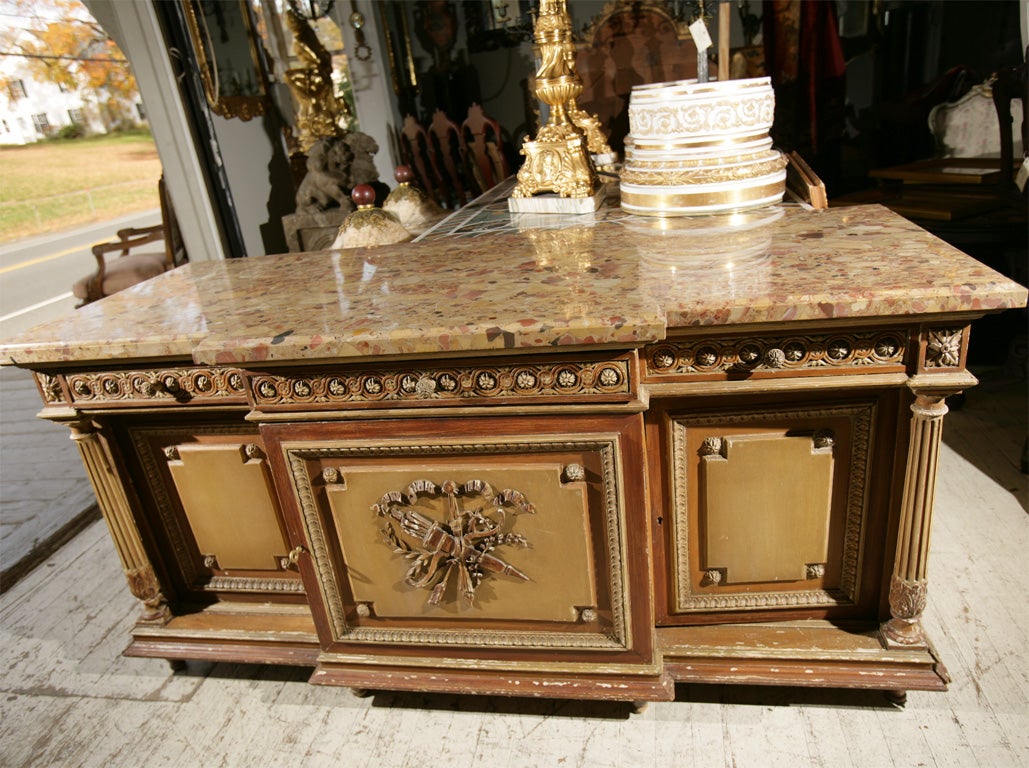 A PAINTED, FRENCH, 3  DOOR, 3 DRAWER, SIDE CABINET WITH BRECHE D'ALEPE MARBLE TOP. SEPARATE FLUTED COLUMNS, TOUPEE FEET, CARVED CENTRAL MEDALLION, RAISED PANELS, LEAF CARVINGS, CABINETS TAKE ADJUSTABLE SHELVES (NOT INCLUDED)