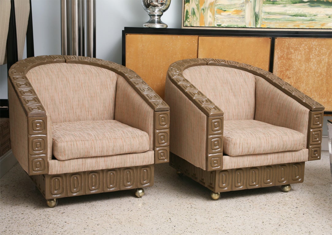 The limed oak frame with geometric carved pattern all-over, with upholstered seat and back, all on brass castors.