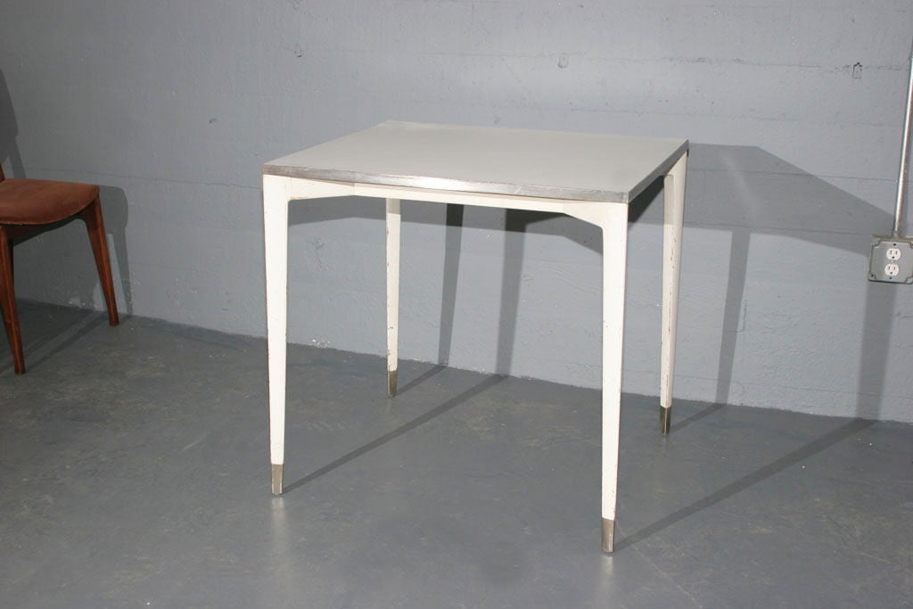 A small dining table by Gio Ponti produced by Cassina for the Bijenkorf department store in Eindhoven 1967.<br />
<br />
Lacquered ash wood with formica top. Metal framed top and sabots. <br />
<br />
Literature: Ugo La Pietra, Gio Ponti, Milan,