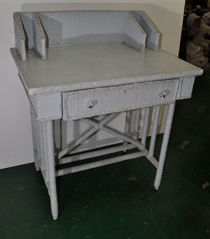 Very heavy painted Victorian wicker desk. A sturdy piece with loads of charm and function. Has the high backsplash and two letter slots on each side, one large front drawer with glass knobs, crossbars, and an attractive back, so it can freestand. It