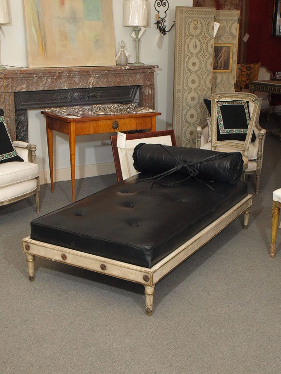 Large bench/coffee table with painted wood frame and leather cushion and bolster. The Jansen mark is on the frame.  The cushion is made of a butter-soft, luxurious, tufted, black leather.  The bolster attaches by tying underneath the cushion,
