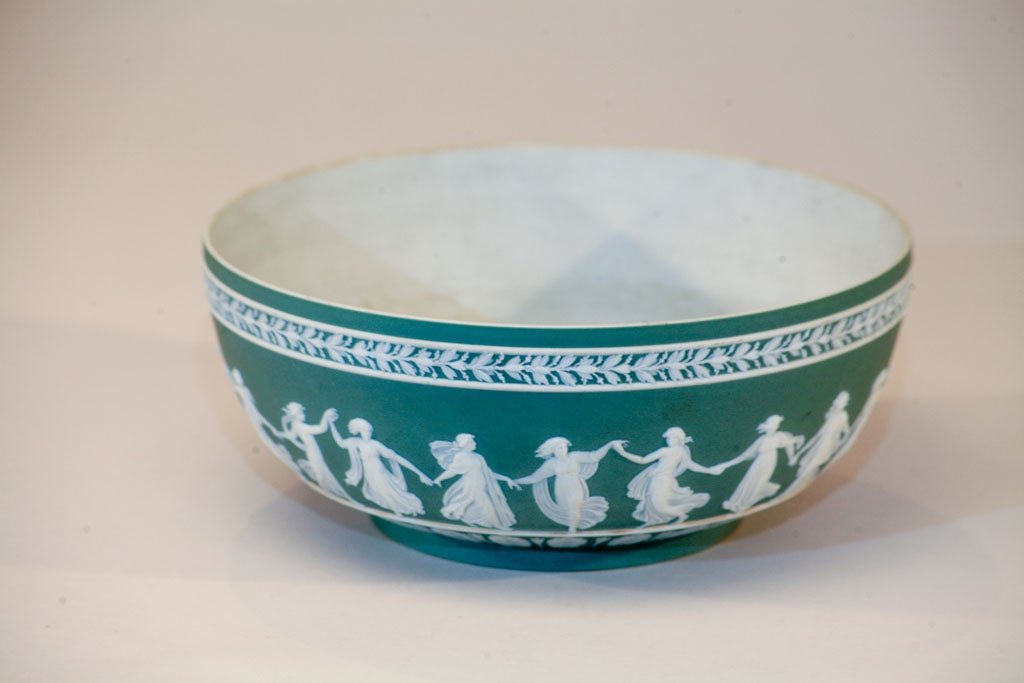 This unusually colored Wedgwood Jasperware bowl features neo-classical bas-relief of dancing maidens encircling the circumference. The quality of the figures and border decoration is fine and delicate with the maidens' diaphanous dresses in 3