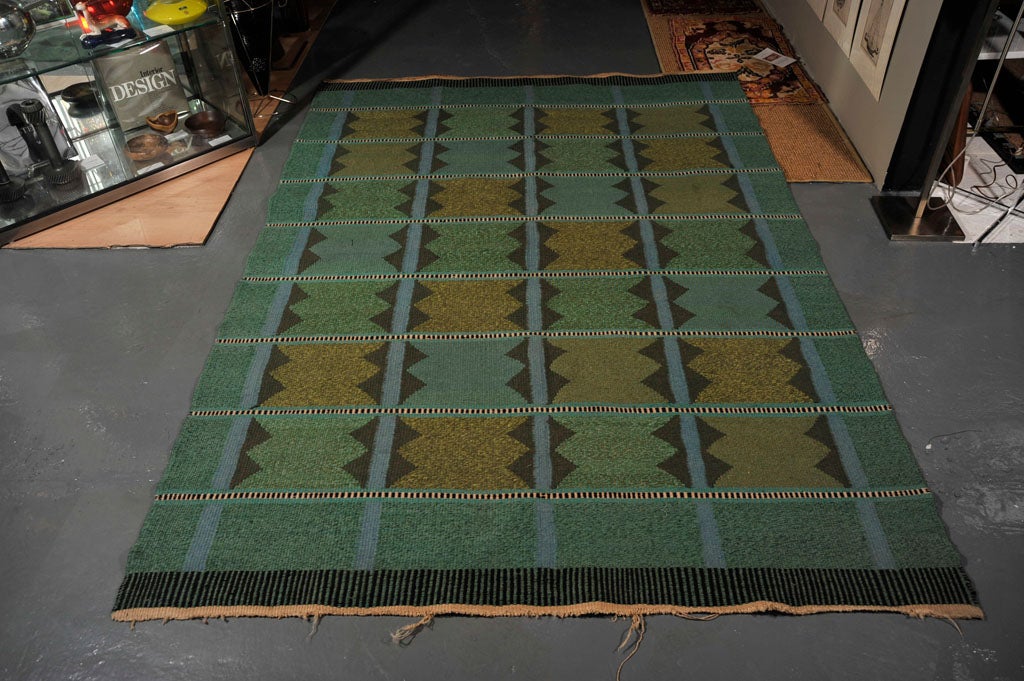 Woolen flat weave rug produced in Sweden, c. 1950's.  Geometric patterning in teal,<br />
green, and charcoal.