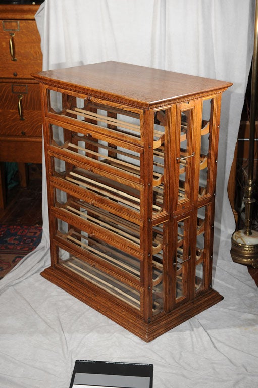 This American oak country store ribbon cabinet is a tough to find collectible piece of furniture.  While its original use was to display and sell ribbons, people now use them as wine racks.  You could get two bottles per shelf, which would mean