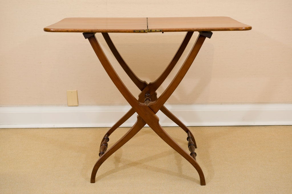 Fine antique English folding Coaching Table in faded and figured mahogany.