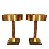 Pair of unusual brass lamps with demilune shades by Laurel