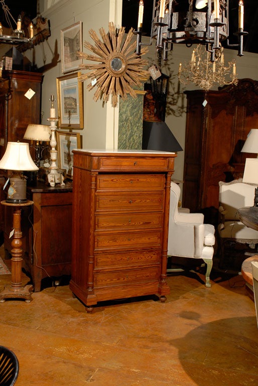 19th Century French Louis Philippe style tall chest with seven drawers (semainier), with an inset marble top.