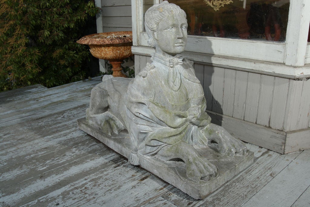 A FINELY CARVED PAIR OF  NATURAL STONE, NOT COMPOSITION, SPHINXES EACH WITH  FEMALE HEADS AND DRAPERY ON LION BODIES. ONE FACES  TOWARDS THE LEFT, ONE TOWARDS THE RIGHT.