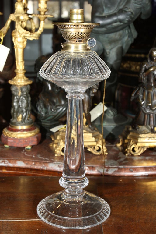 A SOLID CRYSTAL OIL LAMP,  OUTFITTED FOR  ELECTRICITY, OIL FONT, GROUND PONTEL  ON BASE, ADJUSTMENT MARKED  MESSENGER