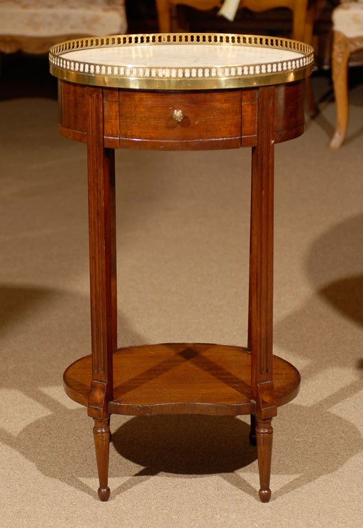 A petite 19th century French oval mahogany side table with white marble top and brass gallery.<br />
<br />
For many more fine antiques, please visit our online gallery at: www.williamwordantiques.com<br />
<br />
William Word Fine Antiques: