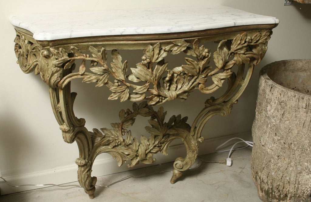 A Magnificent green painted carved wood Louis XV Provençal console with white marble top in olive branch motif.