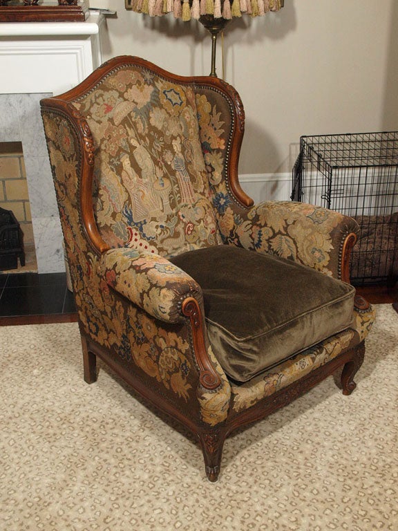 Late 19th c Walnut frame wing chair with needlepoint upholstery and velvet cushion