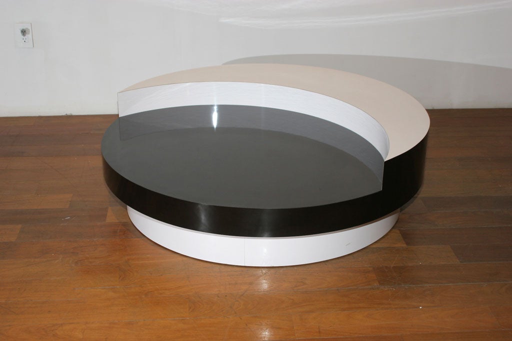 Production version of the famous 1969 revolving table from Sebastien Barquet.Featuring a gloss lacquered black and white color combination, a crescent moon shaped upper tier, over the full diameter circle, in the fashion of a lunar eclipse. An