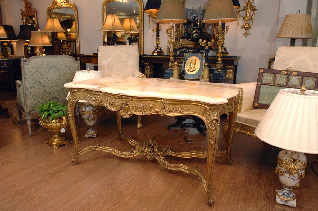 Beautiful 19th Louis XV Gilded salon table with hand carved  detailed stretcher base. 19th Russian onyx top.