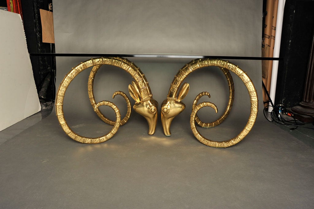 An exquisite pair of sculpted bronze table bases each in the form of a ibex heads with intricate details in the horns. After Chervet. French, circa 1970.