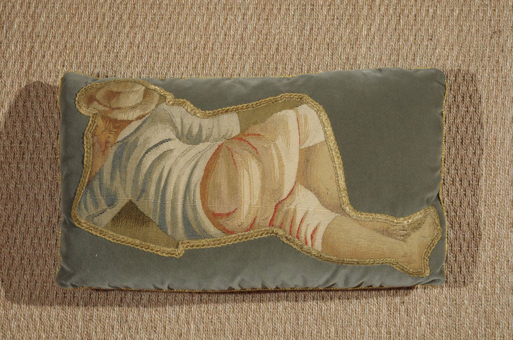 This peaceful fragment of a man lolling on the land evokes a sense of quietude. The dusty blues and tans with a pop of coral in the pant creases are really beautiful with the soft metallic galon. This pillow is incredible on a burlap wingback or on