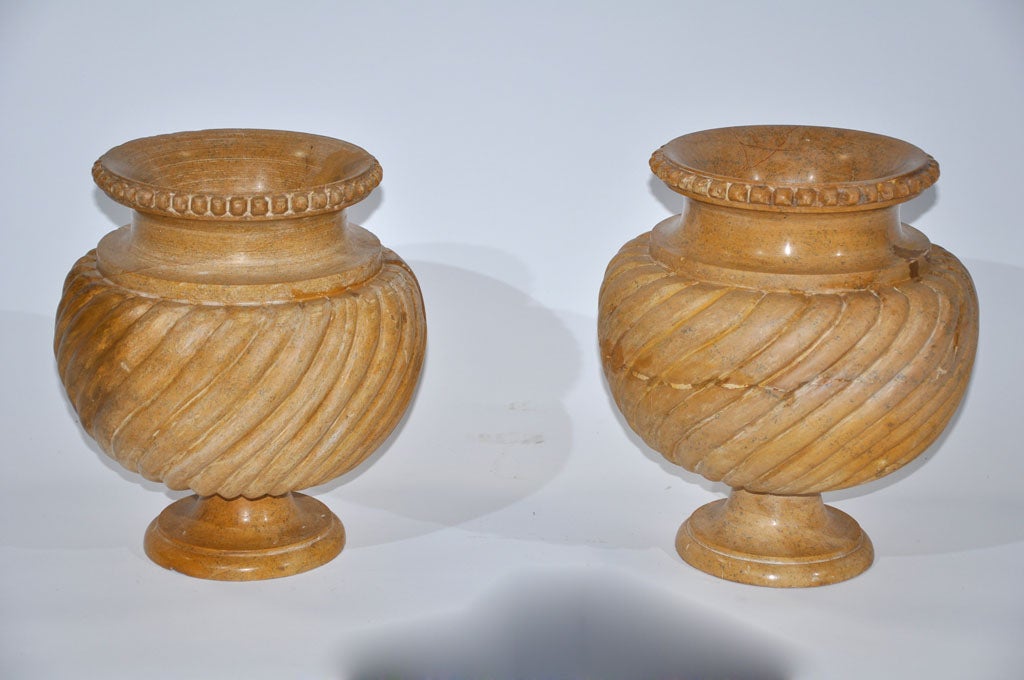 Wonderful pair of Jaselmar urns from India in a warm ochre limestone.  Decorative elements that can be used functionally are always a welcome addition to any space.