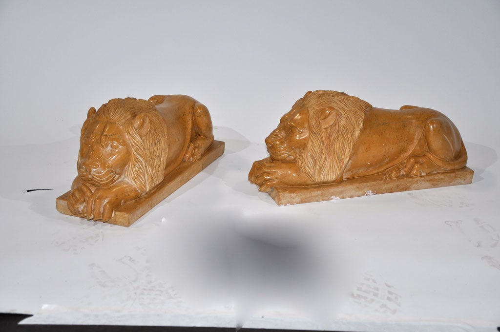 These regal hand carved lions 'in repose' are made from the deep ochre Jaisalmer stone. This wonderful pair would be elegant flanking a fireplace or used as substantial bookends in a library.
