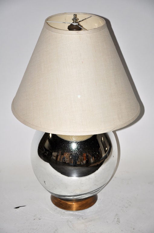 Wonderful vintage Mercury glass table lamp by Bruce Eicher with a double light fixture. This lamp fits into a wide range of design styles, from modern to classic. It would be a wonderful addition to a sitting room or on a bedside table. 

Shade