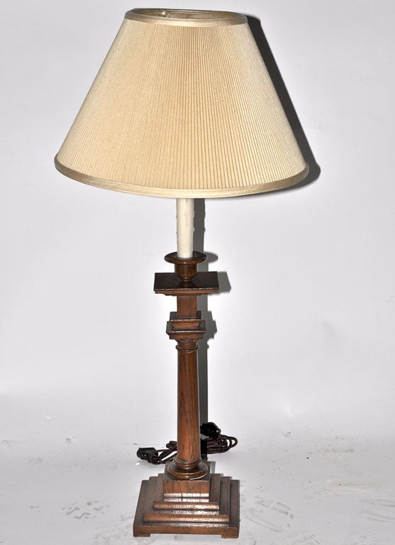 Lovely oak column candlestick converted into a lamp, circa 1930. The tapering shaft is mounted on a stepped square base. This lamp would be perfect on a desk in a library or creating the perfect ambience to curl up and read a book in a cozy chair.