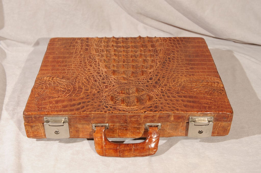 This snazzy alligator attache case is a sight to behold.  Nicely constructed with chrome plated hinges and a very busy interior, this will make any executive feel that he's a cut above the rest.  A beautiful, unusual item to be cherished.  The