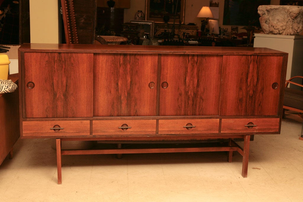 Handsome rosewood sideboard, Danish Mid-Century Modern, with four cupboards and four drawers below, on a stand, Lovig design.