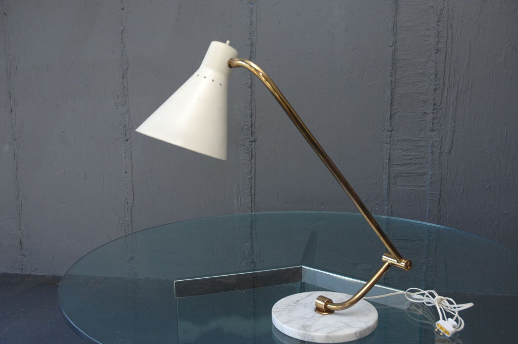 Italian Articulated Table Lamp 
An Off White Enameled Cone Shade Attached to an Adjustable Brass Arm Standing on a Round Marble Base