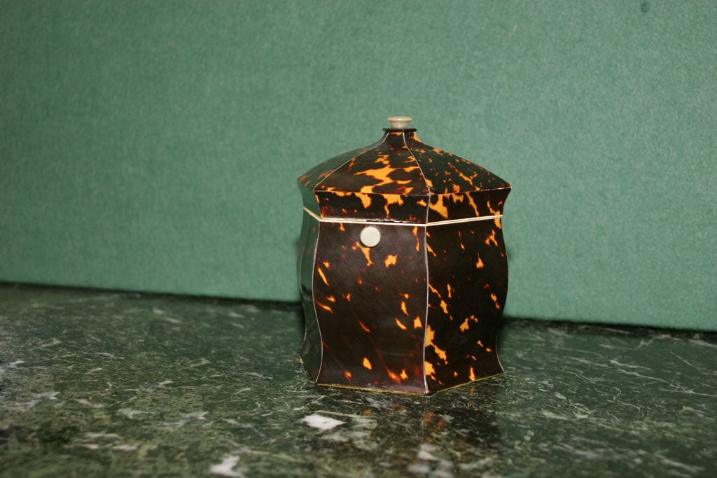 Fine Regency period hexagonal tortoiseshell tea caddy with undulating sides and a pagoda top with mother-of-pearl finial.  The hinged top opens to reveal an ivory and felt lined interior with removable lid. Stamped 