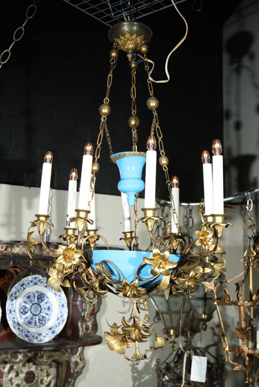 French multi arm bronze chandelier with blue glass inserts.