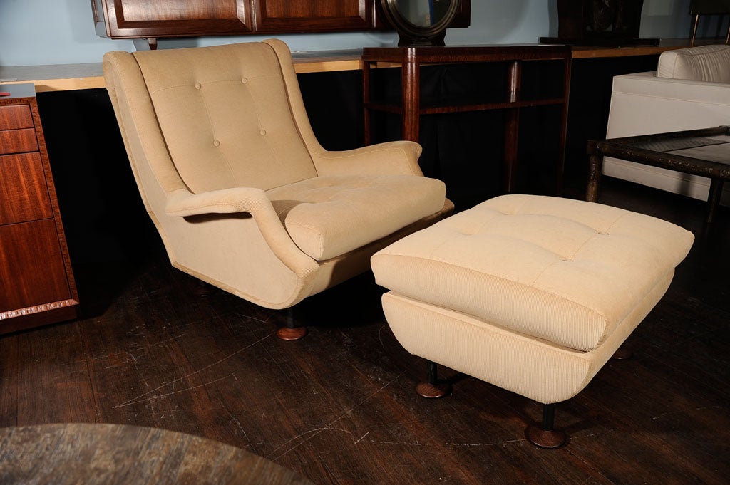 Sculptural lounge chair with matching ottoman.  Upholstered in tan ribbed cotton.  Black metal legs and shaped walnut feet. Very rare to find this model with the matching ottoman.<br />
<br />
Chair:  h. 31 1/2