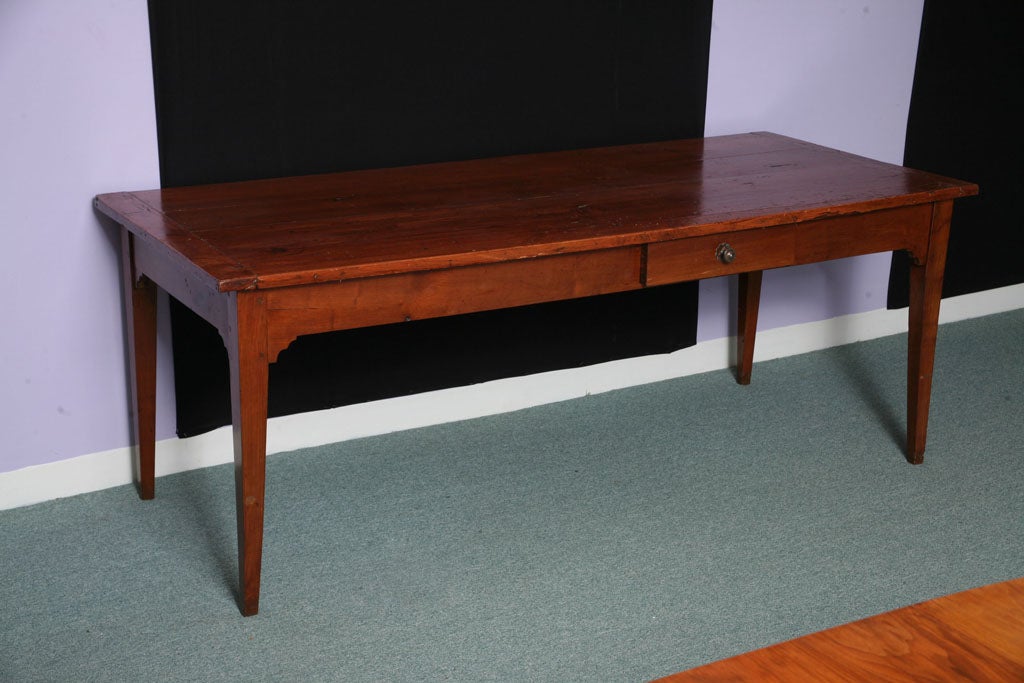 An Antique French Country Dining Table with tapered legs