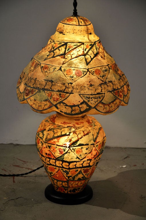 Hand-made, stretched camel skin table lamp with lighted base and shade. Originating from the Middle East which features a detailed hand painted application in vibrant colors. New wood base and new wiring.