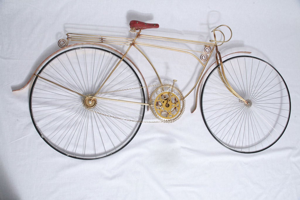 Unique life size bicycle sculpture by C. Jere. A very true representation of an actual bicycle in brass metal with rubber tires and seat cover. Attached decorative hooks for easy mounting. Signed and dated.