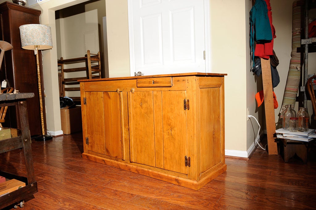 This is a gorgeous primitive pine store counter.  It was in horrible condition when we got it and thus needed to be refinished.  It is finished on all sides so it can float in a room if you'd like.  Wood make a beautiful buffet!