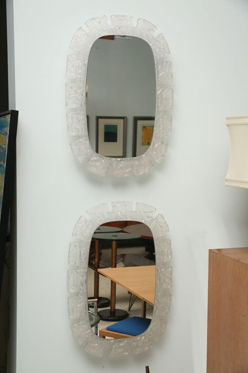The Perspex frame with mirror plate mounted on a nickel-plated wall light- illuminated from behind. One available.