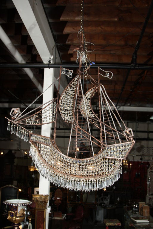 Unusual chandelier, the iron Galleon frame with intricate crystal decorations. Mask, Bow and Stern Light as well as the body of the Galleon. There is a pair the price is for ONE CHANDELIER.