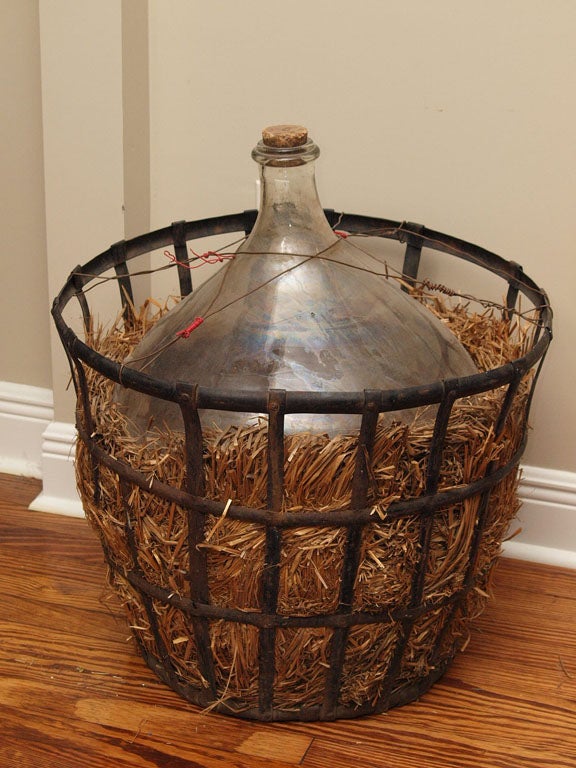 19th century French Wine jug with original iron storage cage and straw.
