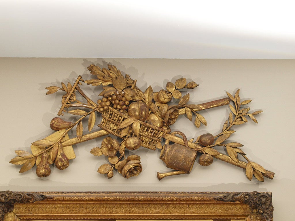 Exceptional 18th c French Gilt wood carving of a basket with farm implements, fruit and flowers.