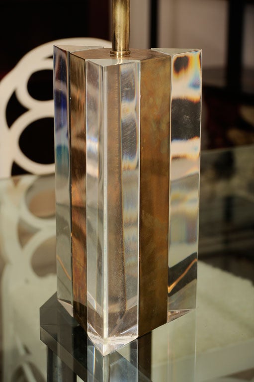 Triangular table lamp in brass and Lucite, with two lights.<br />
Signed: Gabriella Crespi