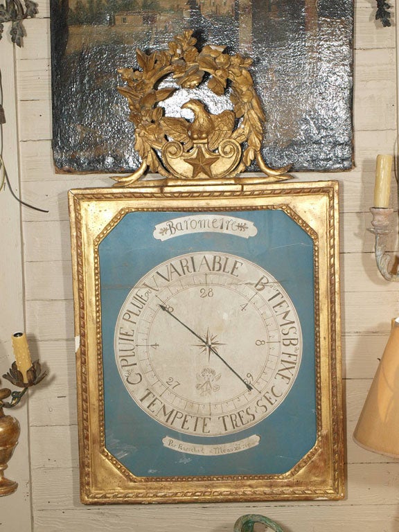 18th century French gilt framed barometer topped with eagle inside a floral garland.  The face of the Barometer is painted on paper.