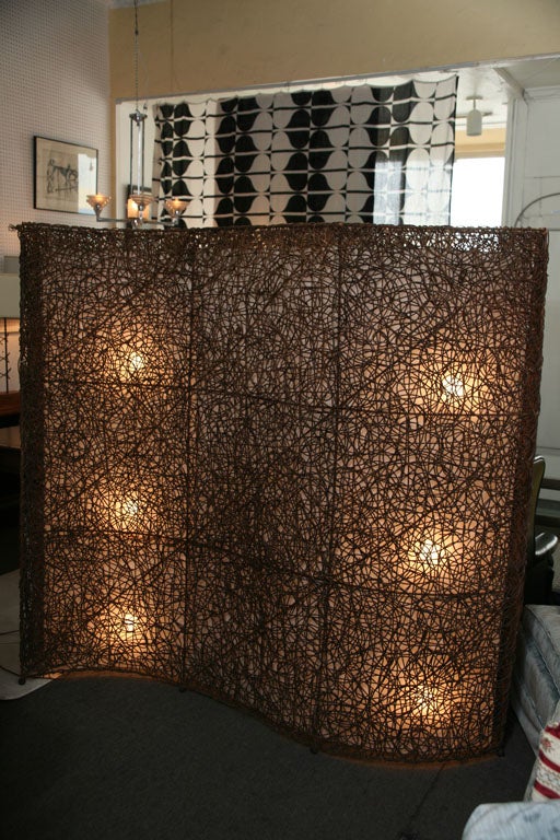 Constructed from grapevines with an insert lamp shade cotton material all attached to a metal frame. Very sturdy this is a wonderful decorative screen/room divider that will bring an organic accent to any space. Three switch will light up 9 light