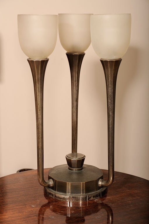French Art Deco pair of table lamps in patinated and nickeled bronze base with frosted glass shades, signed Codure.