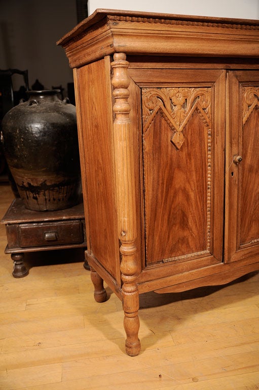 Carved teak cabinet in art nouveau style, pillared sides.