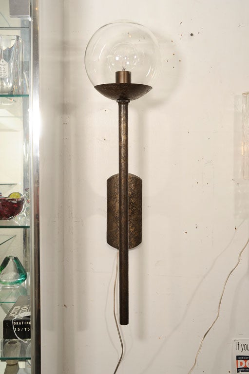 Single unique wall sconce with antiqued textural bronze finish. This sconce can be either interior or exterior. 