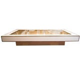1980'S IVORY LACQUERED COFFEE TABLE TRIMMED IN BRASS