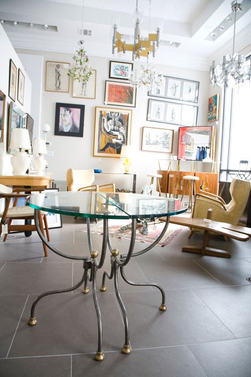 Brushed  steel wrought iron tables with glass tops and brass hardware.